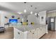 Spacious open-concept kitchen with granite countertops, hardwood floors, and an island with bar seating at 404 Bowstring Dr, Huger, SC 29450
