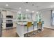 Modern kitchen with stainless steel appliances, granite countertops, and stylish bar seating, perfect for entertaining and everyday living at 404 Bowstring Dr, Huger, SC 29450