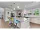 Bright eat-in kitchen with stainless appliances, granite counters, and colorful breakfast bar seating at 404 Bowstring Dr, Huger, SC 29450