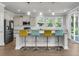 Well-lit kitchen with stainless steel appliances, granite countertops, and comfortable seating at the island, a perfect gathering spot at 404 Bowstring Dr, Huger, SC 29450