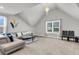 Cozy living room with sloped ceiling, chandelier, modern sofa, and large window with neighborhood view at 404 Bowstring Dr, Huger, SC 29450