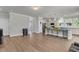 Open concept living area featuring wood floors and access to the kitchen at 404 Bowstring Dr, Huger, SC 29450