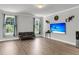 Cozy living room featuring wood-look floors and natural light from large windows at 404 Bowstring Dr, Huger, SC 29450