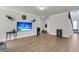 Spacious living area featuring wood-look floors and a large television at 404 Bowstring Dr, Huger, SC 29450