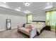 Serene main bedroom featuring a sitting bench, tray ceiling and neutral color palette at 404 Bowstring Dr, Huger, SC 29450