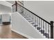 Modern staircase with dark wood railing and detailed metal spindles at 404 Bowstring Dr, Huger, SC 29450