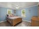Comfortable bedroom with hardwood floors, two windows, and ceiling fan at 407 Raysor St, Saint George, SC 29477