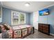 Serene bedroom with calming blue walls, a patterned quilt bed, and a modern flat-screen television at 407 Raysor St, Saint George, SC 29477