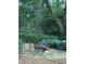 Backyard fire pit with chairs in a lush, green setting with shade trees at 4150 Nature View Cir, Johns Island, SC 29455