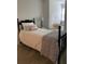 Comfortable bedroom with a black spindle bed, accent pillows, and a cozy window seat at 4150 Nature View Cir, Johns Island, SC 29455