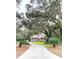 Picturesque home with a long driveway, lush landscaping, and a welcoming front porch at 4150 Nature View Cir, Johns Island, SC 29455