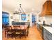 A kitchen features a dining table, custom cabinets, tile backsplash and a wood vent hood at 4150 Nature View Cir, Johns Island, SC 29455