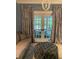Charming living room with blue accents, plush seating, and backyard access through elegant french doors at 4150 Nature View Cir, Johns Island, SC 29455