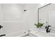 All-white bathroom with walk-in shower and black hardware at 42 Poinsett St # B, Charleston, SC 29403
