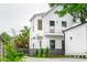 Two story home boasts white siding, a balcony, dark framed windows, and well-manicured landscaping at 42 Poinsett St # B, Charleston, SC 29403