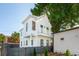 Two story home boasts white siding, a balcony, dark framed windows, and well-manicured landscaping at 42 Poinsett St # B, Charleston, SC 29403