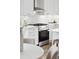 Kitchen view featuring stainless appliances, white subway tile backsplash, and granite countertops at 42 Poinsett St # B, Charleston, SC 29403