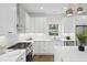 Modern kitchen with stainless steel appliances, white cabinets, and modern lighting at 42 Poinsett St # B, Charleston, SC 29403