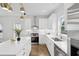 Modern kitchen with stainless steel appliances, white cabinets, a kitchen island and modern lighting at 42 Poinsett St # B, Charleston, SC 29403