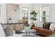 Living room features a brown leather sofa, modern furniture, and plenty of natural light at 42 Poinsett St # B, Charleston, SC 29403