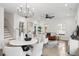Bright and airy living room with a modern chandelier, staircase, and ample natural light, creating an inviting atmosphere at 42 Poinsett St # B, Charleston, SC 29403