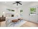 Light-filled main bedroom features a comfortable bed, side tables, and ample windows, creating a serene and relaxing atmosphere at 42 Poinsett St # B, Charleston, SC 29403