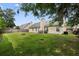Spacious backyard featuring a well-maintained lawn, patio area, and mature trees, perfect for outdoor entertaining at 432 Equinox Cir, Ladson, SC 29456