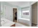 Well-lit bathroom includes a walk-in closet, soaking tub, and tile flooring at 432 Equinox Cir, Ladson, SC 29456