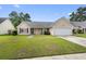 Inviting single-story home with manicured lawn, featuring a classic design and attached two-car garage at 432 Equinox Cir, Ladson, SC 29456