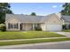 Lovely one-story home with a well-kept lawn, an attached garage, and neat landscaping for great curb appeal at 432 Equinox Cir, Ladson, SC 29456