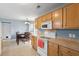 Cozy kitchen with wooden cabinets, white appliances, and a dining area, perfect for Gathering meals at 432 Equinox Cir, Ladson, SC 29456