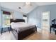 Spacious bedroom features light wood flooring, blue walls, and a connecting bathroom at 432 Equinox Cir, Ladson, SC 29456