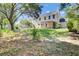 Large, grassy backyard featuring an outdoor living space with an enclosed porch at 434 Antebellum Ln, Mount Pleasant, SC 29464