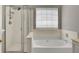 Bathroom with separate shower stall and soaking tub under a window at 434 Antebellum Ln, Mount Pleasant, SC 29464