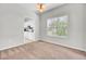 Neutral-toned dining room leading into the kitchen featuring carpeted flooring and natural lighting at 434 Antebellum Ln, Mount Pleasant, SC 29464