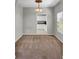 Neutral-toned dining room leading into the kitchen featuring carpeted flooring and natural lighting at 434 Antebellum Ln, Mount Pleasant, SC 29464