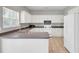 Functional kitchen with white cabinets, dark countertops, stainless steel sink, and view to the yard through the window at 434 Antebellum Ln, Mount Pleasant, SC 29464