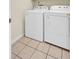Bright laundry room with a washer and dryer on tiled floors at 434 Antebellum Ln, Mount Pleasant, SC 29464