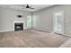 Inviting living room with fireplace, ceiling fan, tile flooring on one side, and outdoor access at 434 Antebellum Ln, Mount Pleasant, SC 29464
