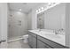 Modern bathroom featuring a double vanity with stone countertop and tiled walk-in shower at 4436 Oakwood Ave, North Charleston, SC 29405