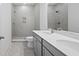 Modern bathroom featuring a double vanity with stone countertop and tiled walk-in shower at 4436 Oakwood Ave, North Charleston, SC 29405