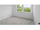 Bright bedroom with plush carpet and a view to the greenery outside at 4436 Oakwood Ave, North Charleston, SC 29405