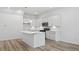 Bright kitchen features white cabinets, stainless steel appliances, and quartz countertops with a kitchen island at 4436 Oakwood Ave, North Charleston, SC 29405