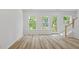 Living room with natural light, wood-look floors, access to the outdoors and a staircase at 4436 Oakwood Ave, North Charleston, SC 29405