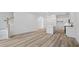 Spacious open-concept living room featuring modern wood-look flooring, abundant natural light and modern staircase at 4436 Oakwood Ave, North Charleston, SC 29405