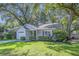 Beautiful single-story home with manicured lawn, mature trees, and attached garage at 512 Castle Hall Rd, Mount Pleasant, SC 29464