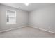Bright, carpeted bedroom featuring a window, neutral paint, and ample natural light at 514 Purple Finch Rd, Summerville, SC 29486