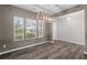 Dining room with large windows and contemporary chandelier at 514 Purple Finch Rd, Summerville, SC 29486