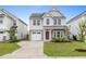 Charming two-story home with an attached garage, manicured lawn and inviting entrance at 514 Purple Finch Rd, Summerville, SC 29486