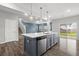 Modern kitchen featuring a large island with seating and sleek stainless steel appliances at 514 Purple Finch Rd, Summerville, SC 29486